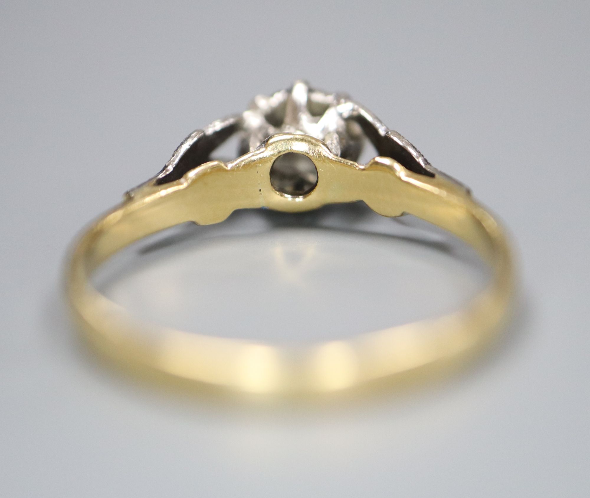 A 1960s 18ct gold and plat, illusion set solitaire diamond ring, size L, gross 2.3 grams.